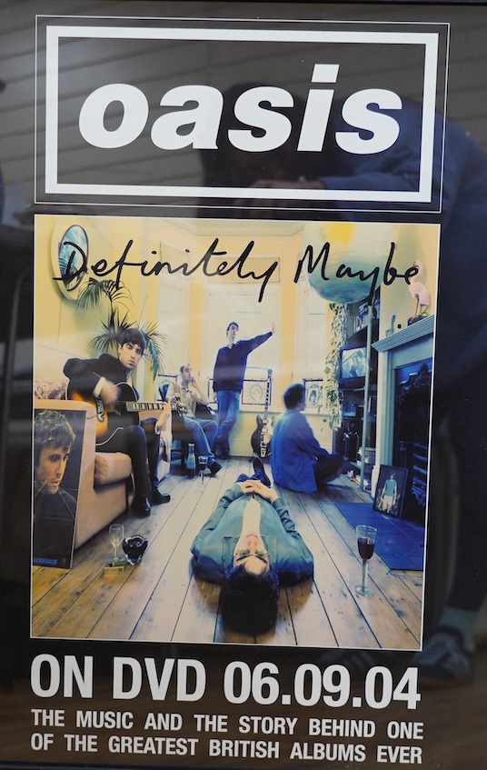 A framed Oasis Definitely Maybe DVD poster, 69 x 49cm. Condition - good